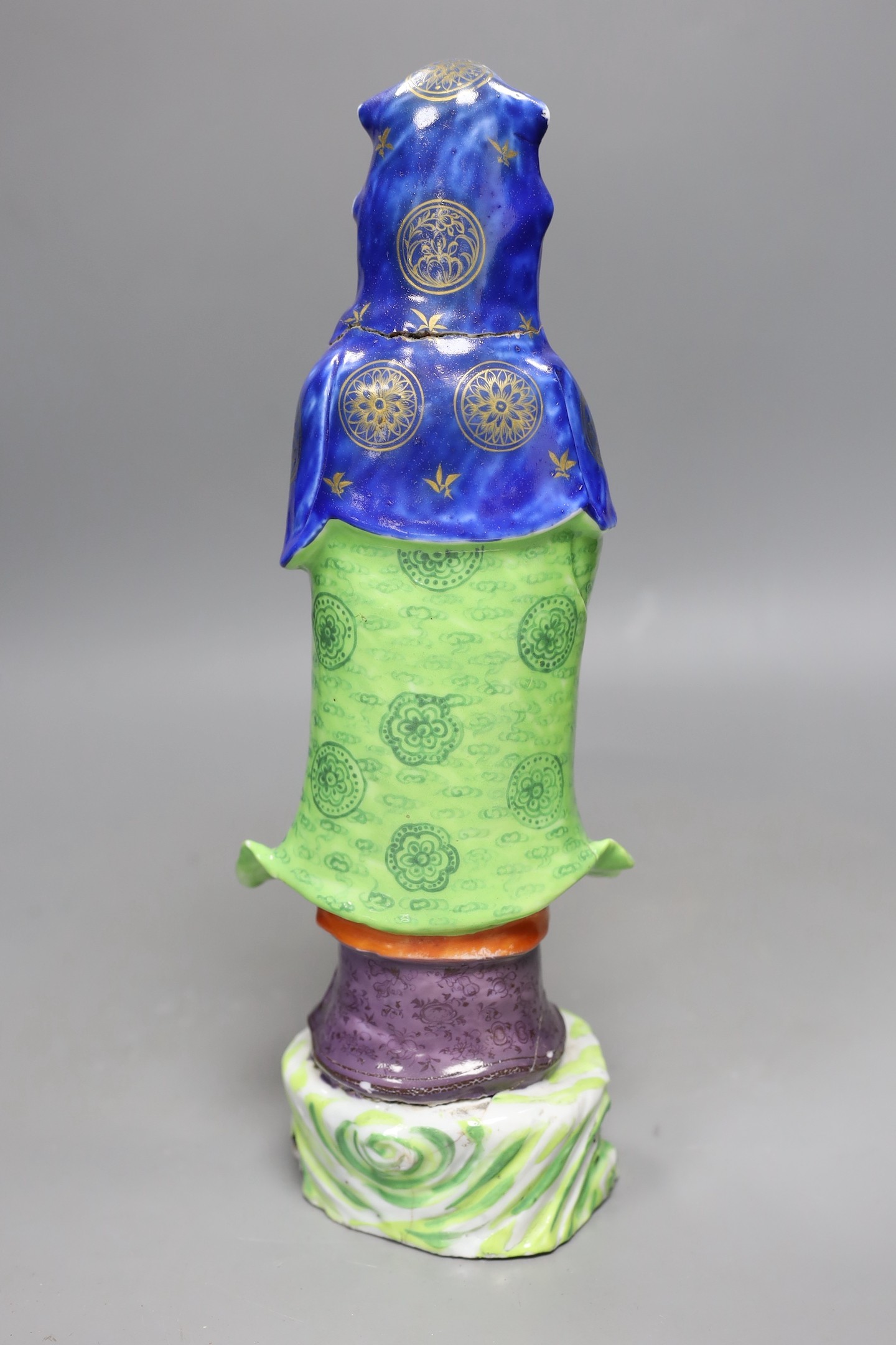 A Chinese enamelled porcelain figure of Guanyin, Jiaqing - Daoguang period, damage, 34cms high